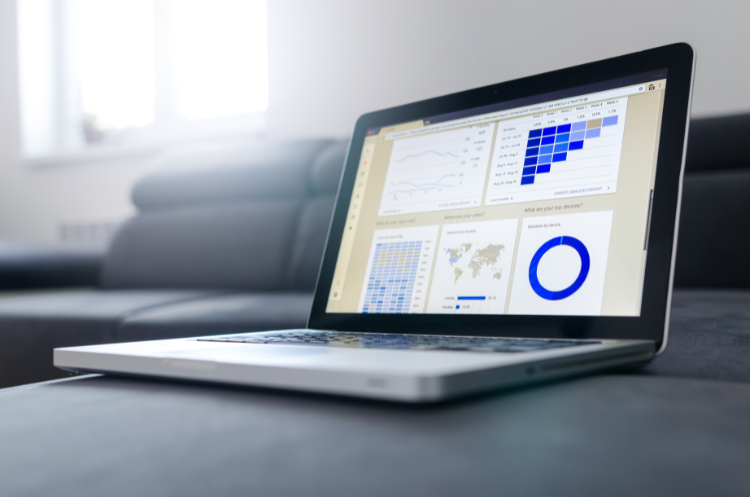 Why Every Business Needs a Technical Advisor for Strategic Growth Laptop displaying business analytics dashboard with charts, graphs, and data visualisations.