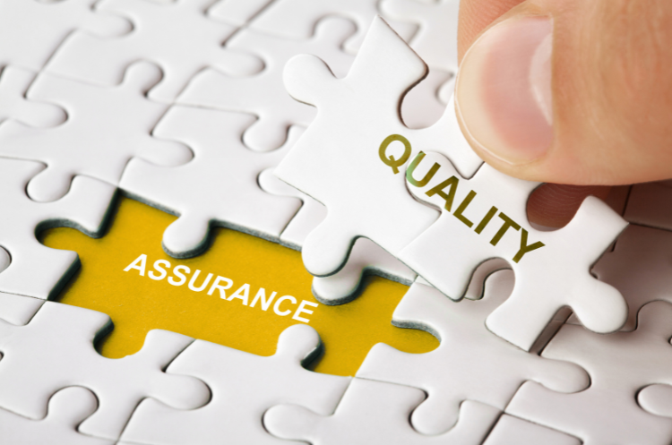 Puzzle pieces connecting with words Quality and Assurance, symbolizing quality assurance consulting and process improvement