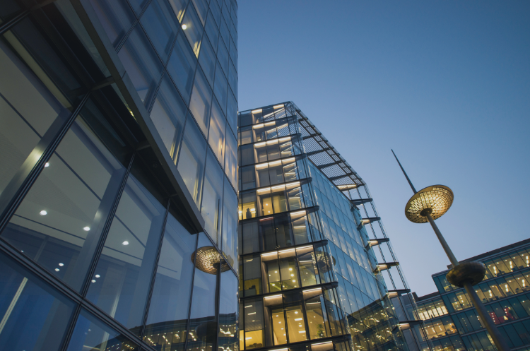 Modern glass office building exterior at dusk, symbolizing corporate governance and independent director leadership in business