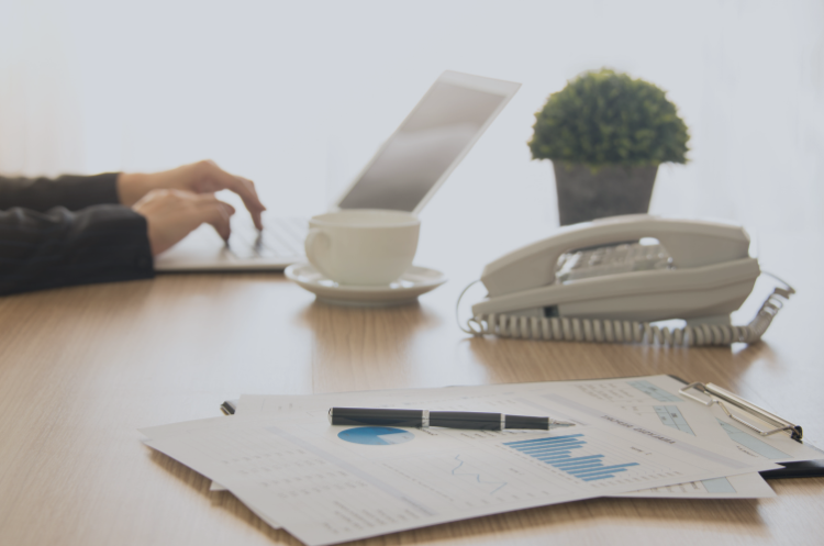 Corporate secretary and governance concept with business reports, desk phone, and administrative workspace setup.