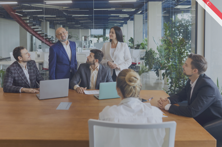 A group of business professionals in a boardroom meeting representing the roles and responsibilities of an Executive Director in Singapore.