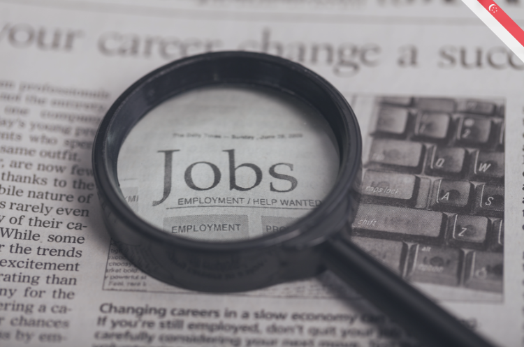 A magnifying glass hovering over a "Jobs" newspaper classifieds section, highlighting the best jobs after 50 in Singapore for experienced professionals.