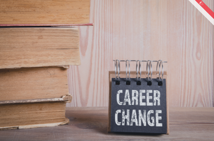 A stack of books and a sign reading "Career Change," serving as a guide to career change after 50 in Singapore for senior professionals.