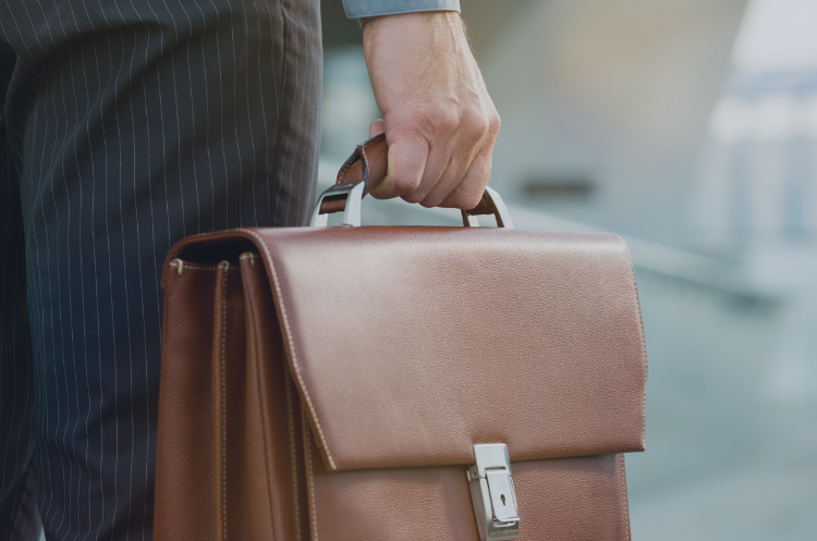 Experienced professional in business attire carrying a leather briefcase, representing flexible part-time career opportunities for seniors and seasoned professionals in Singapore.