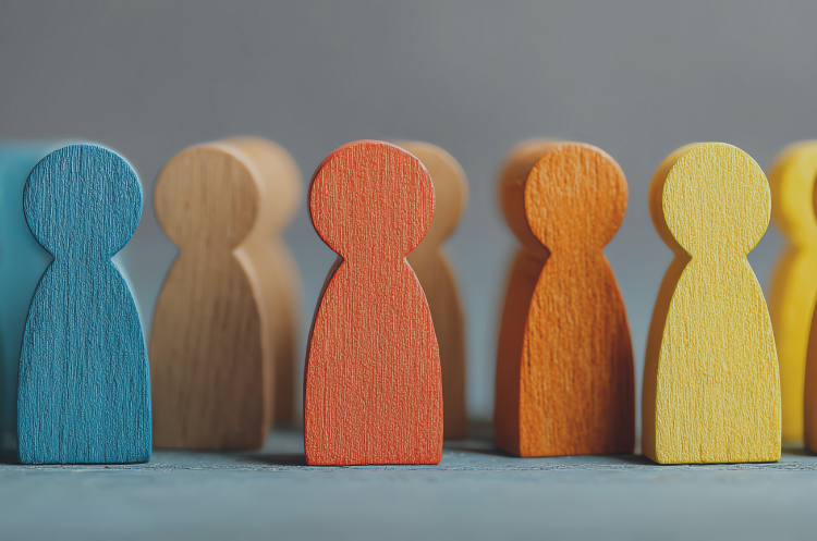 Colorful wooden figures representing diverse employees, teamwork, collaboration, and employee engagement strategies in Singapore workplaces.
