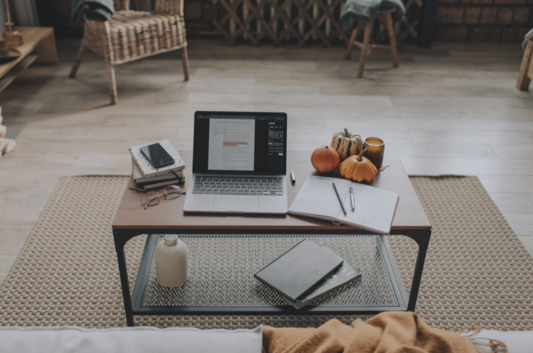 Home office workspace with a laptop, notebook, smartphone, and desk setup representing remote jobs and flexible work opportunities in Singapore.