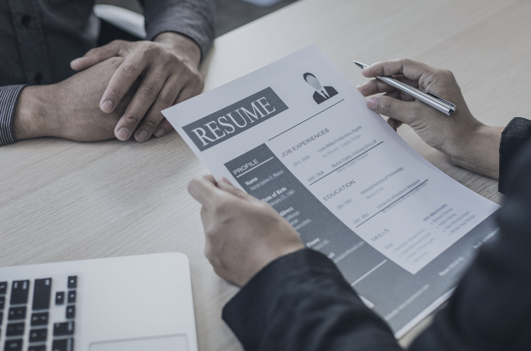 Job interview with a recruiter reviewing a candidate's resume, representing part-time job opportunities in Singapore.
