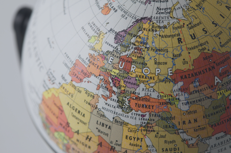 **Alt Text:** Close-up of a globe highlighting Europe, symbolizing regional leadership, international markets, and cross-border business operations.