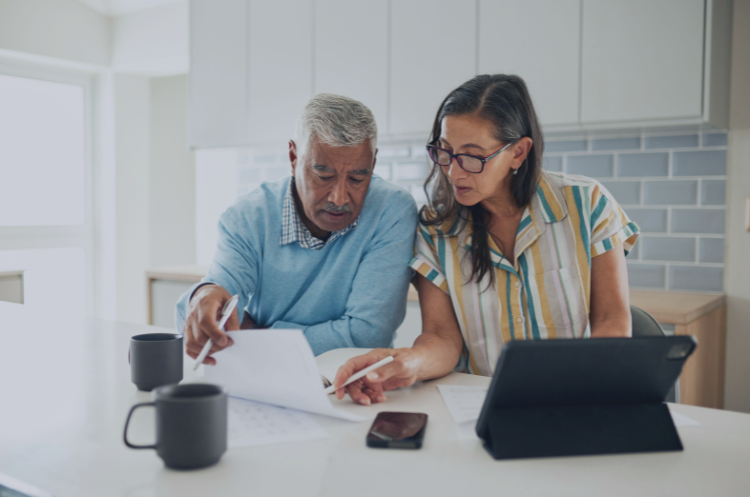 Experienced professionals reviewing career documents together after a career break